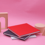 Red, black and white sparkling photobooks stacked on top of each other.